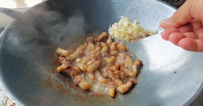 Add 1 teaspoon of fish sauce and 1 tablespoon of chopped garlic. Stir-fry until fragrant.
