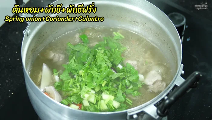 Add shallots, spring onions, coriander, parsley, and roasted chilies.