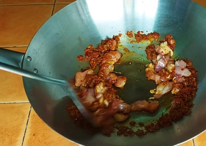 Add the chicken to the curry paste and stir-fry until cooked through. Add water if it gets too dry.
