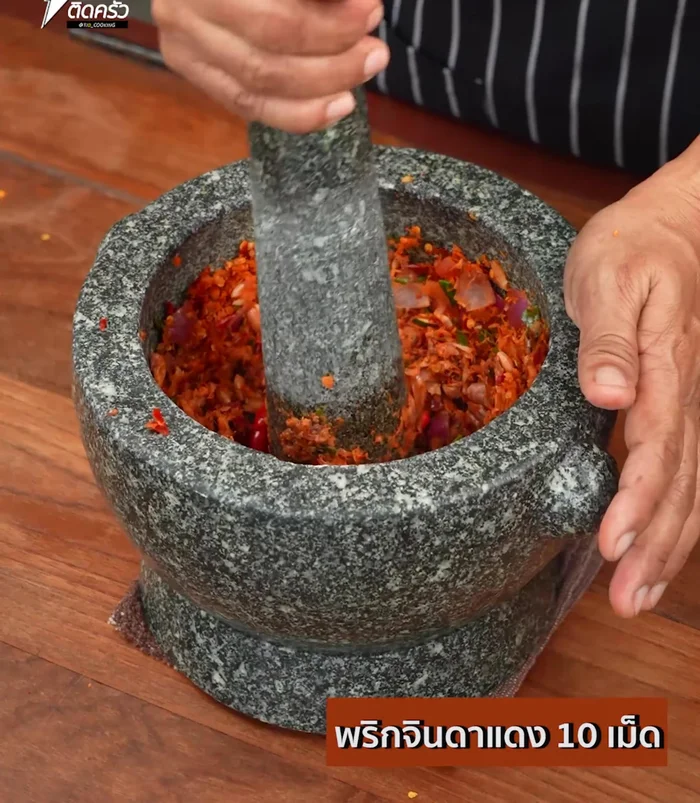 Add fresh chilies, roughly pound, and set aside. This creates a spicy curry paste.