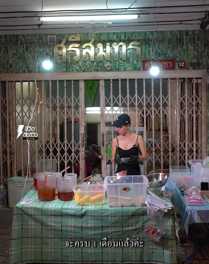 The shop owner, Pae, prepares the salad using fresh ingredients, including selecting the shrimp daily.