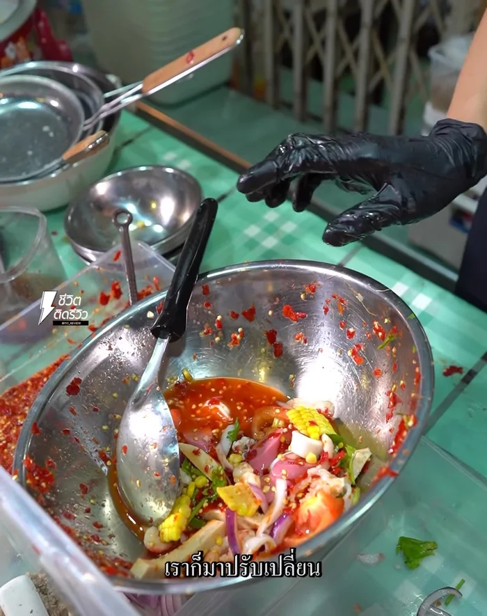 The salad includes shrimp in fish sauce, and the exact recipe varies, but the main ingredients remain.