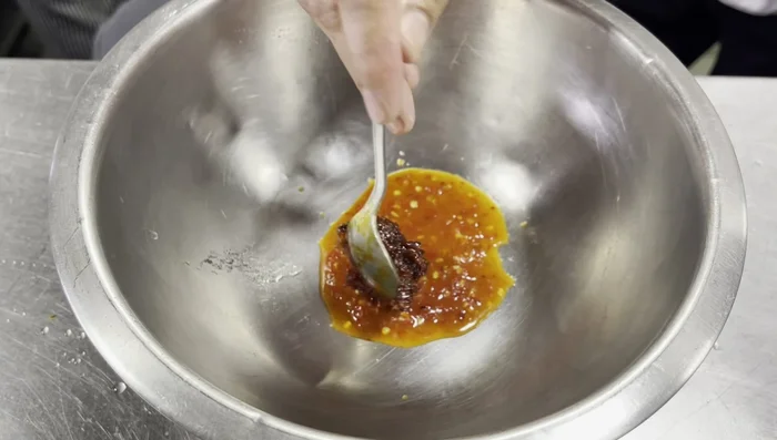 Prepare the sauce: Mix Somtam sauce (or its ingredients), onion slices, mint leaves, and coconut milk powder. Set aside.