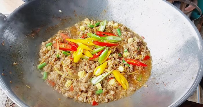 Add red, green, and yellow chili peppers, kaffir lime leaves.