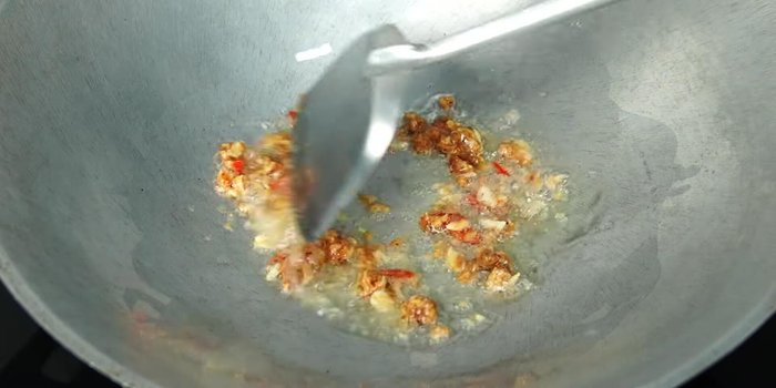 Add the garlic, chili, and shrimp paste mixture and stir-fry until fragrant and slightly yellow.
