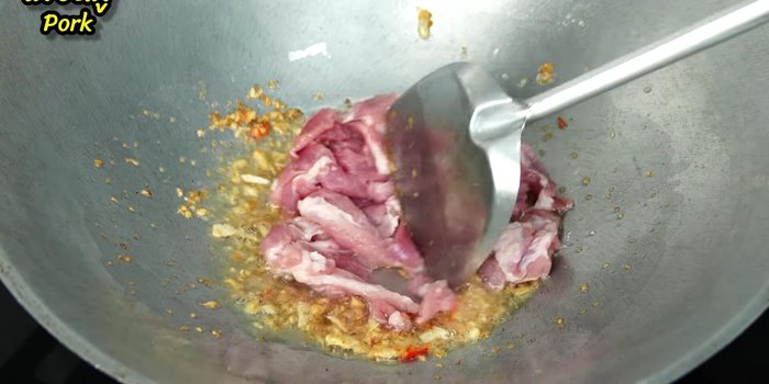 Add thinly sliced pork and stir-fry until partially cooked.