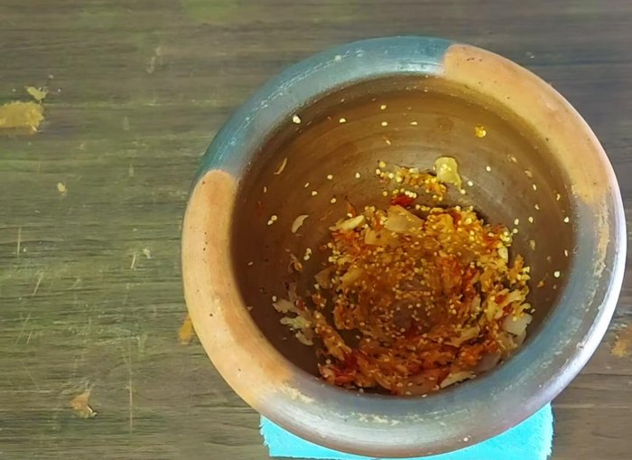 Finely pound the roasted chilies in a mortar and pestle.