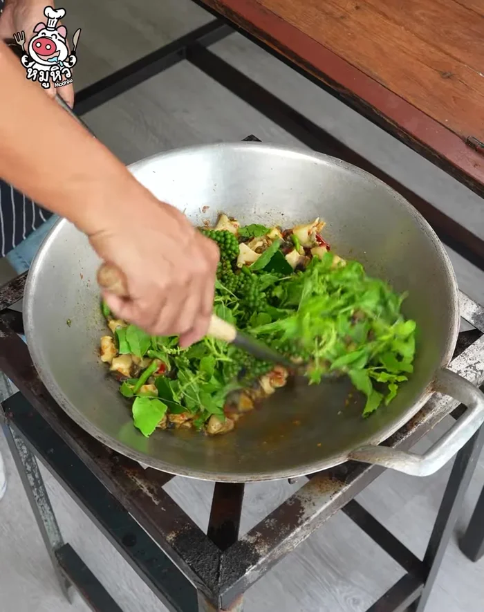 Add lime, chili, and young pepper. Stir-fry until vegetables are wilted.