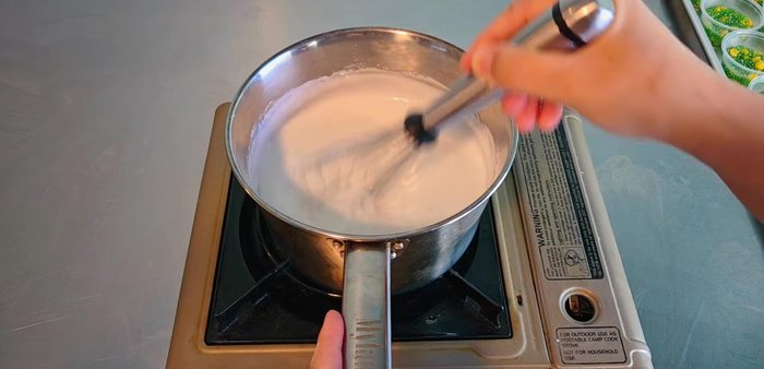 Stir constantly over low heat until the mixture thickens and the surface develops thin cracks. Turn off the heat and let it cool slightly.