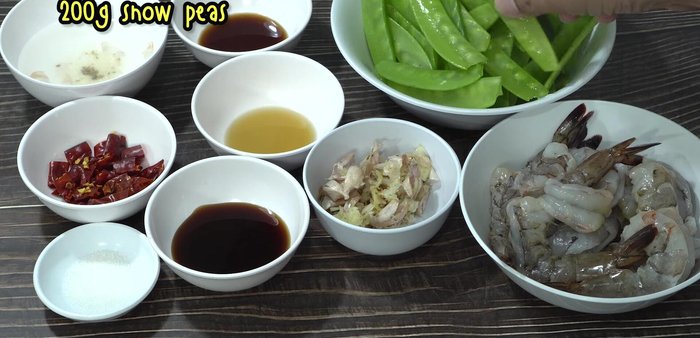 Prepare the snow peas by removing tough strings from both sides.