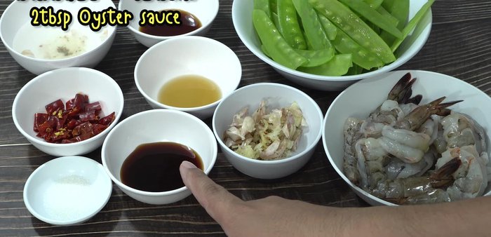 Pound garlic and dried chilies together in a mortar and pestle.