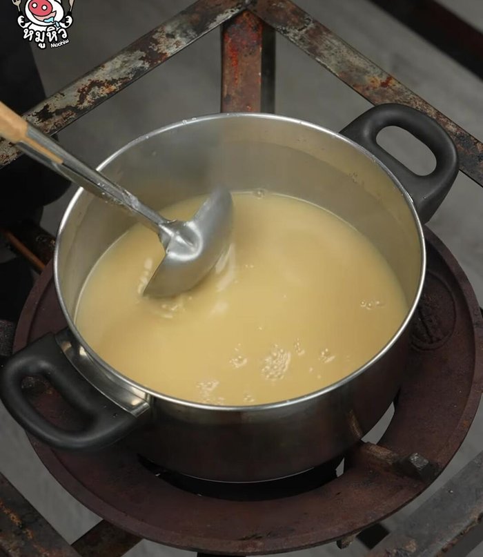 Add young coconut to the boiling coconut milk mixture. Rub it in and mix well.