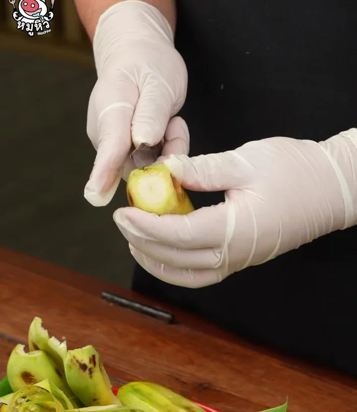 Peel the ripe bananas and wear gloves to avoid sticky sap.