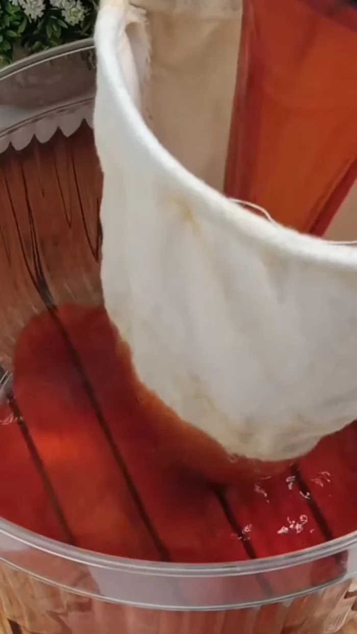 Prepare a container. Strain the tea using a cloth strainer.