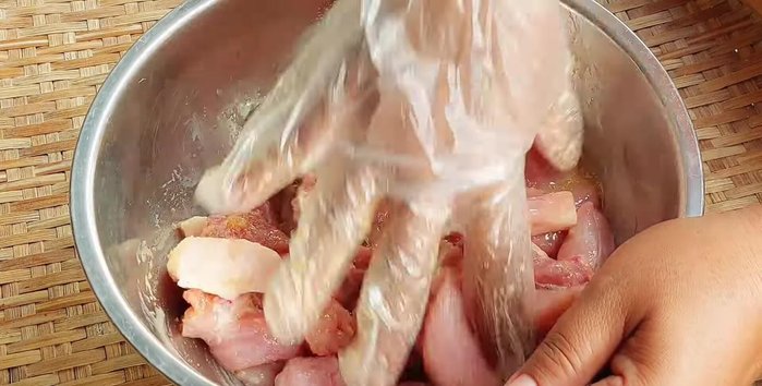 Add the pork to the marinade and massage thoroughly until all seasonings are absorbed.
