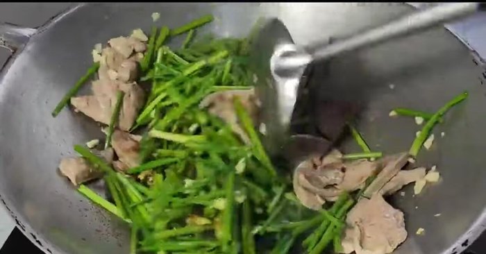 Continue stir-frying until all ingredients are mixed well and chives are cooked.