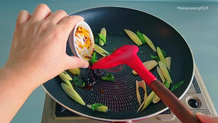 Add 1 tablespoon of chili paste and stir-fry until blended with lemongrass and kaffir lime leaves. Use medium-low heat to prevent burning.
