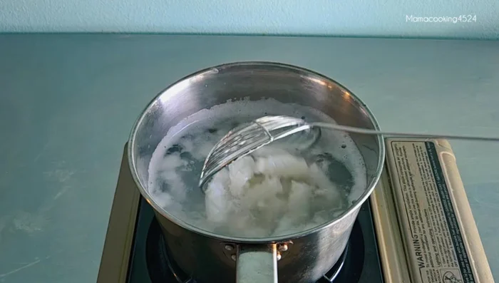 Boil squid using the notch method until it curls and shrinks.