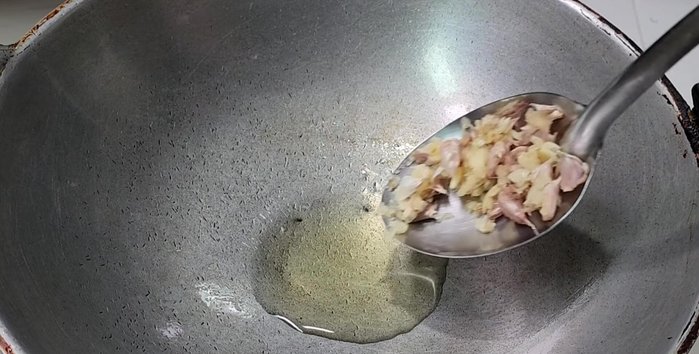 Heat oil in a pan, add garlic and fry until golden brown. Remove and set aside some for garnish.