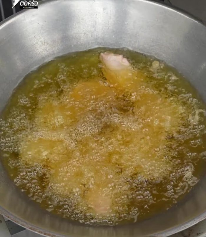 Fry the chicken wings until golden brown and cooked through.