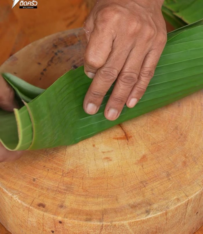 Wrap the rice mixture in banana leaves using two layers. Place about 1 tbsp of rice in the center and wrap the ends tightly, securing with a toothpick.