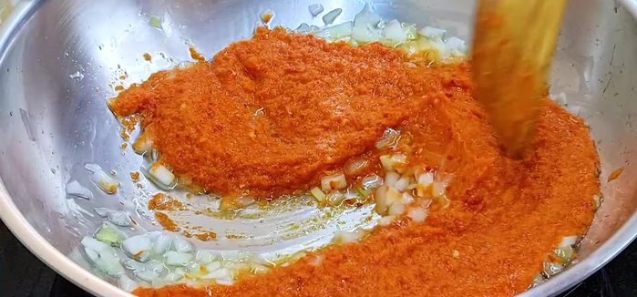 Cook the sambar paste: Pour the sambar paste into the pan, stirring constantly until well combined. Stir frequently to prevent burning. Cook for about 10-15 minutes until the paste is dry and thick.