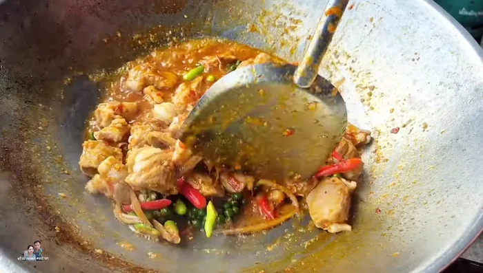 Add sliced chili peppers (about 3) and basil leaves to taste. Stir-fry to combine.
