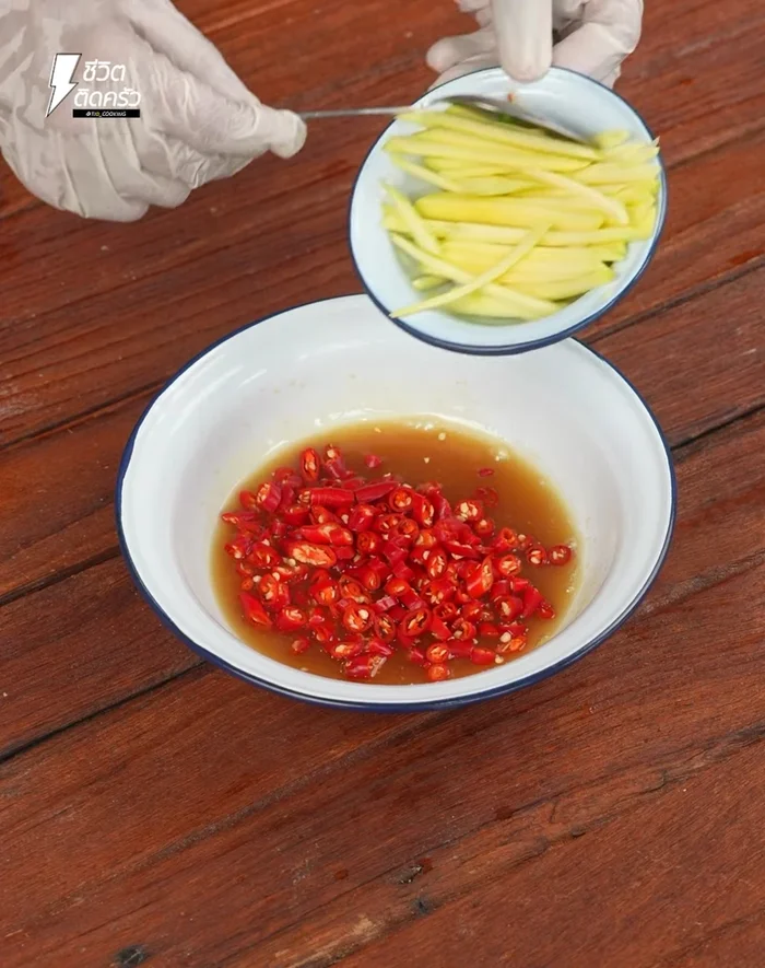 Combine the fried fish, sliced chili, mango, shallots, and chives in a bowl. Add the dressing and mix well.