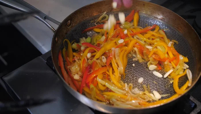 Add sliced garlic and cook briefly.