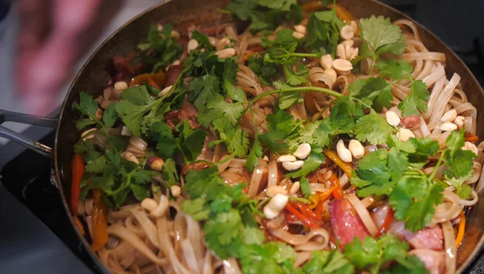 Garnish with fresh cilantro and peanuts.