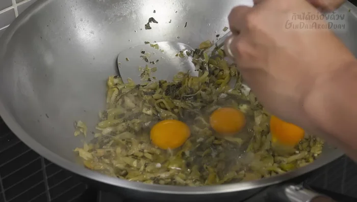 Add the eggs to the pan and stir-fry until cooked through, mixing them with the cabbage.