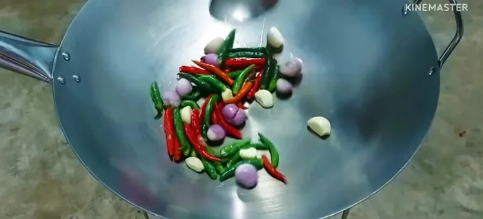 Make the spicy papaya salad: Pound chilies, garlic, and shallots until fine. Season with fish sauce, fermented fish sauce, and lime to taste. Add chopped shallots and coriander. Mix well.