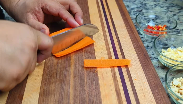 Julienne carrots, halve cherry tomatoes, and prepare snake beans (or blanch green beans).