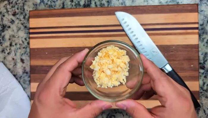 Finely chop palm sugar, red Thai chilies, and thinly slice shallot.