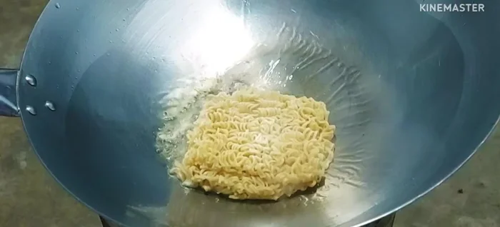 Add the noodles to the hot pan.