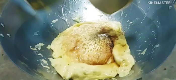 Fry the omelet until cooked through, flipping to cook both sides.