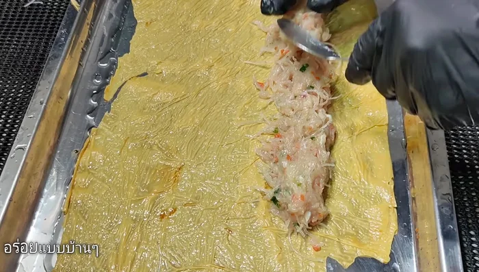 Place the chicken mixture onto the tofu sheets. Roll tightly and tie with string or rope.