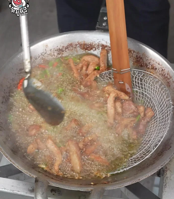 Remove the fried pork, allowing the oil to drain.