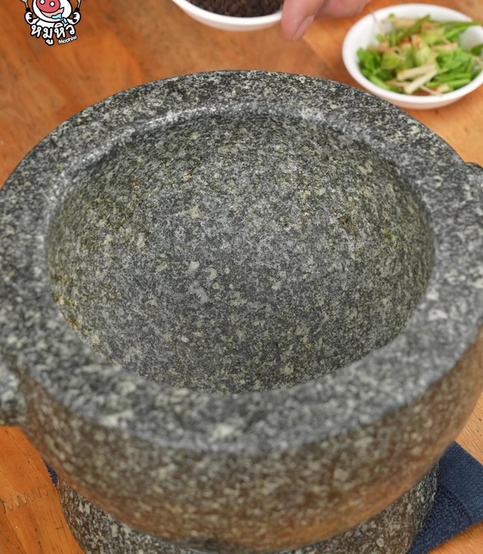 Grind black peppercorns in a bowl.