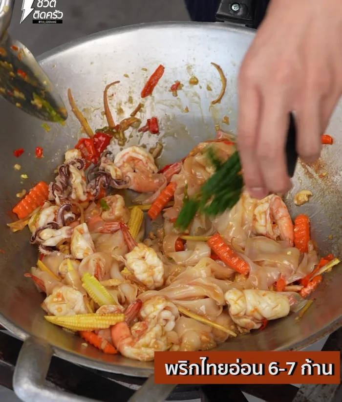 Add young pepper and basil leaves. Stir-fry until done.