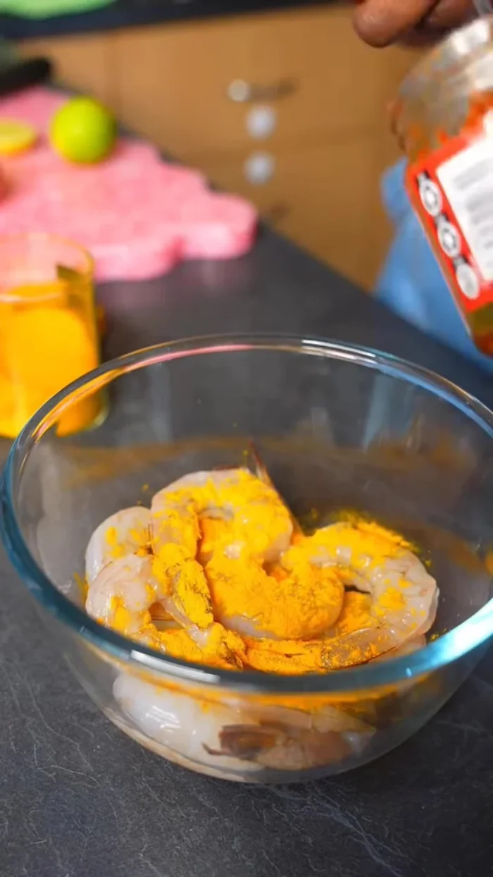 Marinate prawns with turmeric, red curry paste, and lime juice for 30 minutes (or skip marinating if short on time).