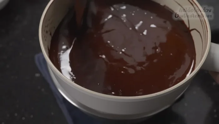 Pour the melted chocolate mixture into the batter and fold until evenly distributed.