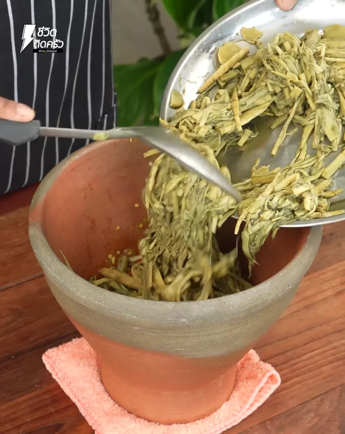 Add the boiled bamboo shoots and pound until all ingredients are well mixed.