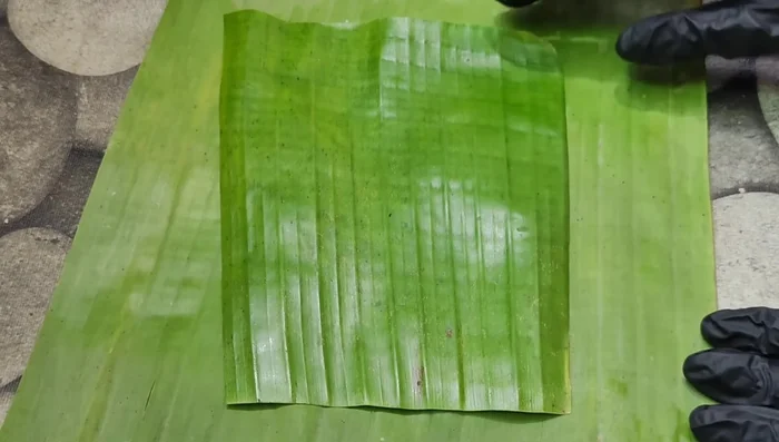 Prepare banana leaves (slightly burn them on gas for softness).
