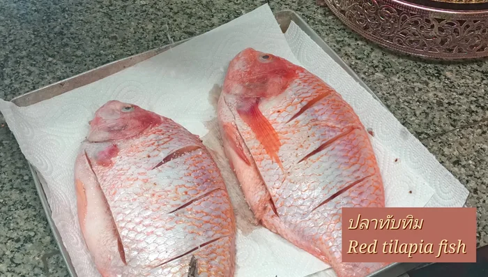 Clean and wash the tilapia. Make neat incisions as needed.