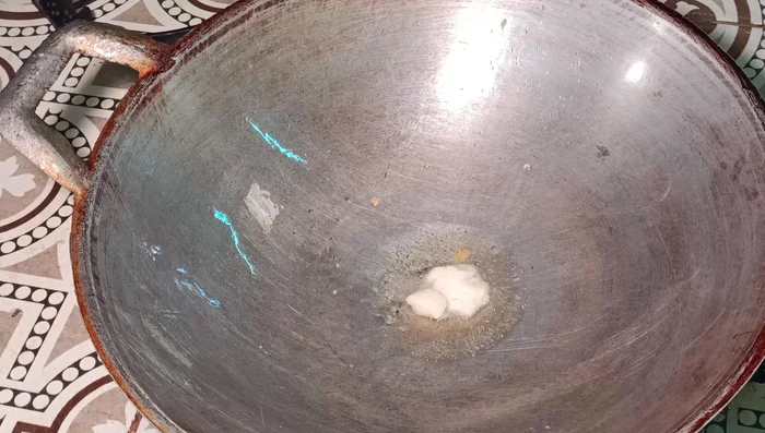 Add the minced pork to the wok and stir-fry until cooked through.