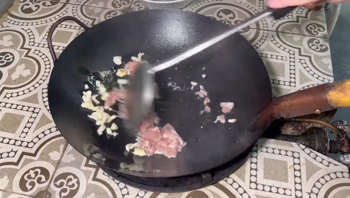 Add minced chicken and stir-fry until cooked.
