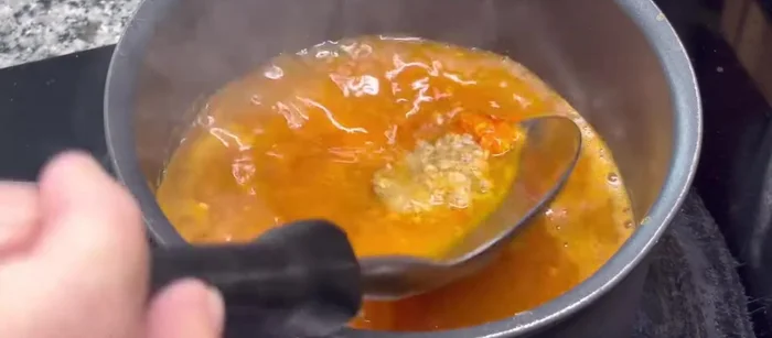 Add sour curry paste.