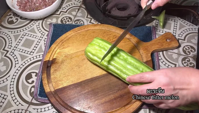 Prepare the bitter melon: Select plump bitter melons. Cut into sections and scoop out the flesh, leaving a shell.