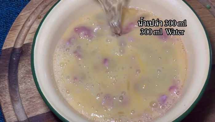 Add 300ml of water to the egg mixture.